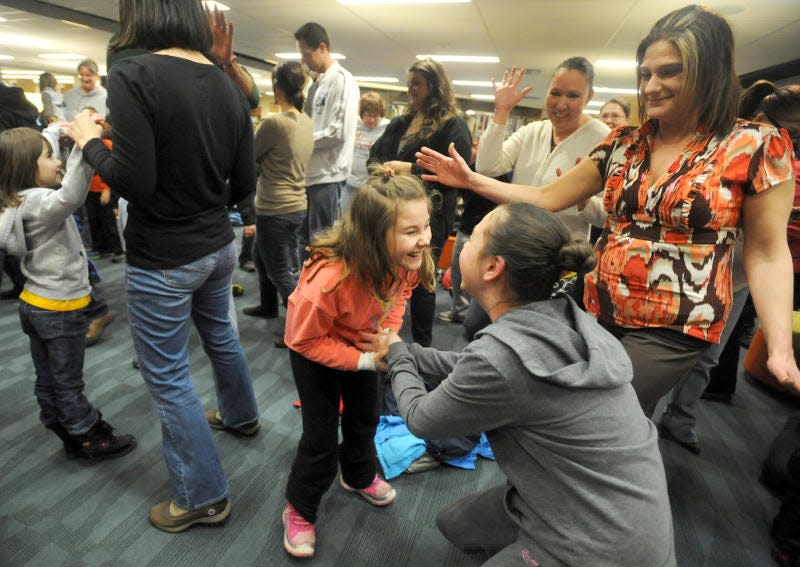 Raelynn Runyon, then 8, (left) and Lilly Runyon, then 10, dance together as they enjoy a song by children's performer Jim Gill at Ellis Library & Reference Center in 2014.
Monroe News file photo