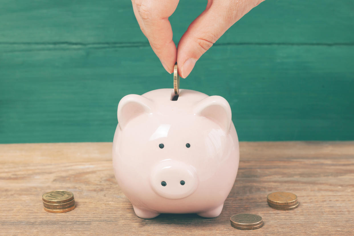 Piggy bank on wooden table with copy space. Savings concept.