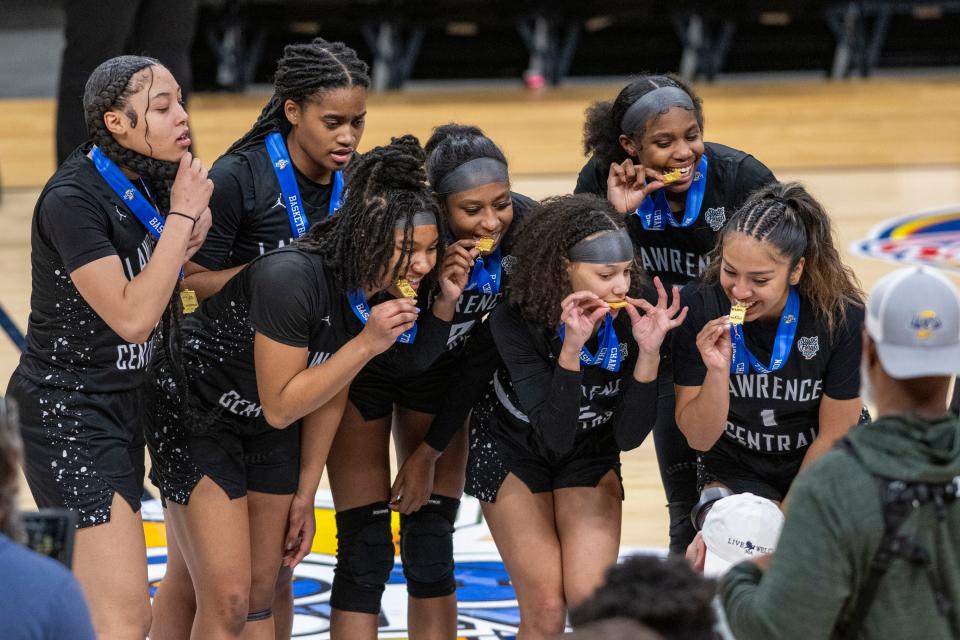 Lawrence Central High School players pose for a photo after being presented medals for winning an IHSAA class 4A girls’ basketball state finals game against Lake Central high School, Saturday, Feb. 24, 2024, at Gainbridge Fieldhouse, in Indianapolis. Lawrence Central won the school’s first state championship title in girl’s basketball.