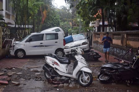 Damaged vehicles are seen following heavy rains in Pune