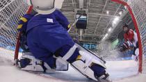 <p>Japan's Shiori Koike (R) tries to score in the women's preliminary round ice hockey match against Sweden.</p>