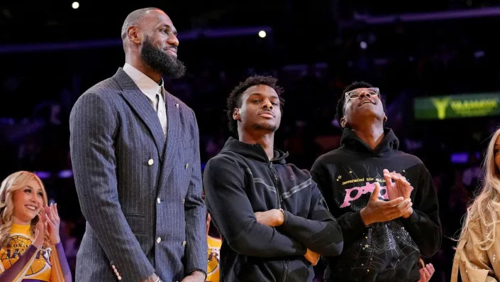 PHOTO: Los Angeles Lakers forward LeBron James, second from left, Bronny James, center, and Bryce James stand during a ceremony honoring LeBron James, Feb. 9, 2023, in Los Angeles. (Mark J. Terrill/AP, FILE)