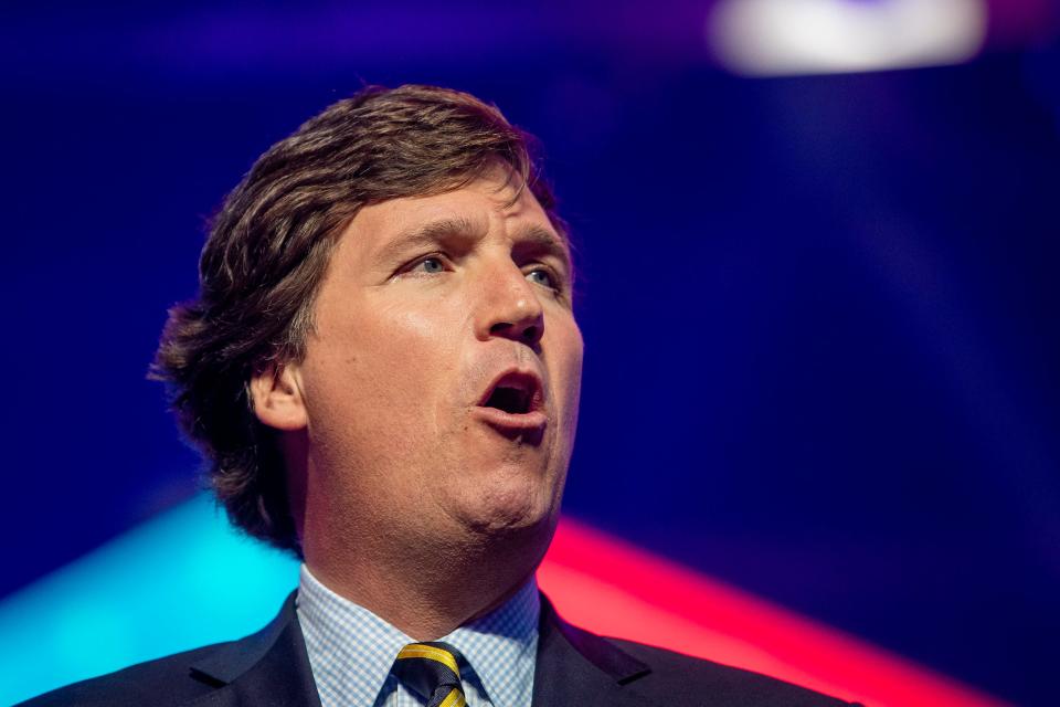 Tucker Carlson speaks during the first day of the America Fest 2021 hosted by Turning Point USA on Saturday, Dec. 18, 2021, in Phoenix. 