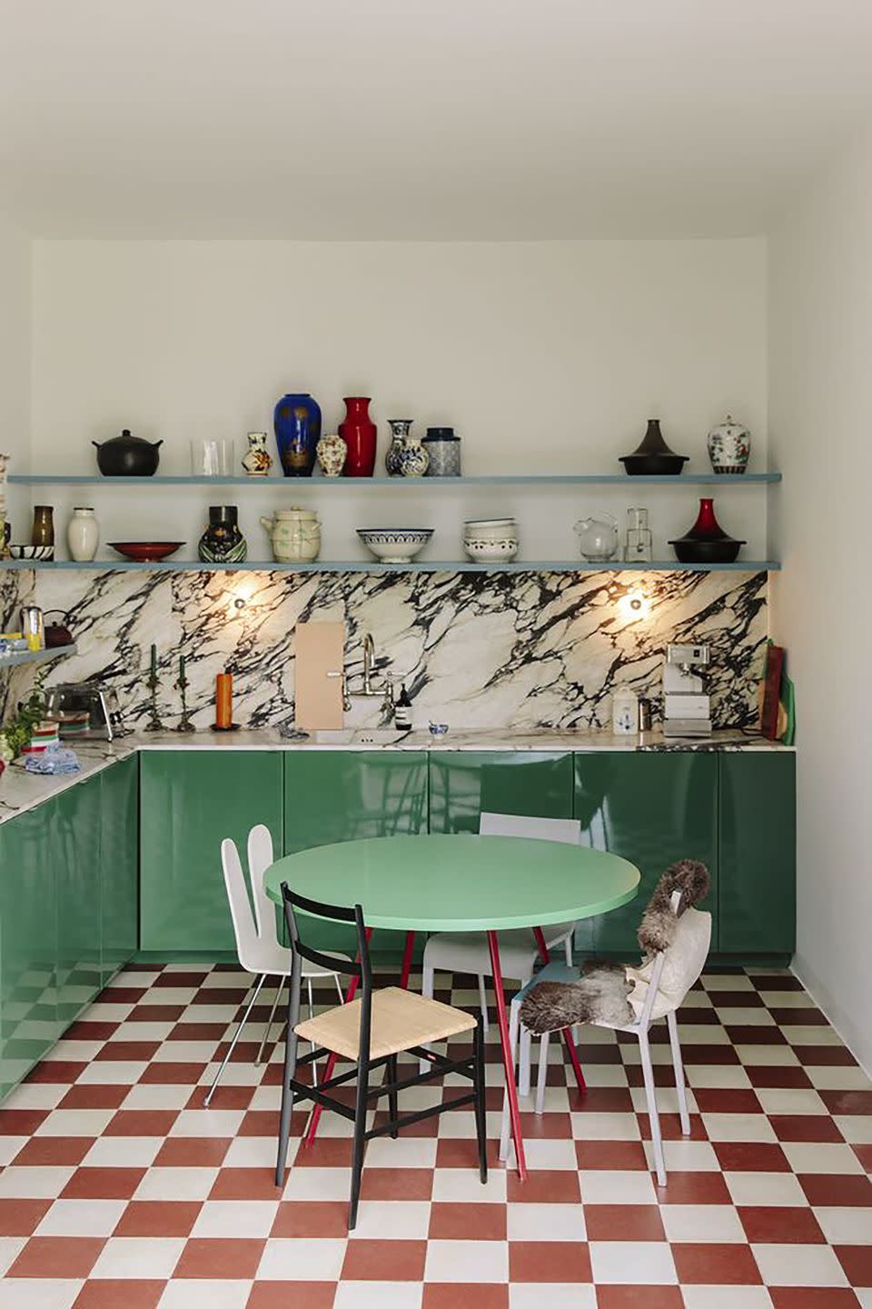 <p>With sea green enamel cabinets, richly veined marble and a red and white checkerboard floor that recalls a 1950s diner, this kitchen by Dutch design duo Muller Van Severen shows that just two hues can be enough to give a space a uniquely personal feel.</p>