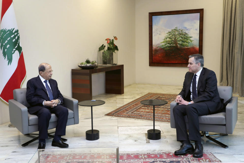 In this photo released by Lebanon's official government photographer Dalati Nohra, Lebanese President Michel Aoun, left, meets with Lebanese Prime Minister-designate Mustapha Adib, at the Presidential Palace in Baabda, east of Beirut, Lebanon, Saturday, Sept. 26, 2020. Adib has resigned Saturday amid a political impasse over government formation, nearly a month after he was appointed to the job. The announced by Adib deals a blow to French President Emmanuel Macron's efforts to break a dangerous stalemate in the crisis-hit country. (Dalati Nohra/Lebanese Government via AP)