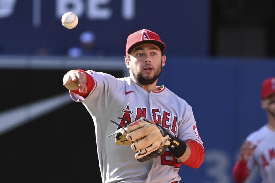 Los Angeles Angels second baseman David Fletcher throws to first base to put out Toronto Blue Jays' Santiago Espinal during the fifth inning of a baseball game, Saturday, Aug. 27, 2022 in Toronto. (Jon Blacker/The Canadian Press via AP)