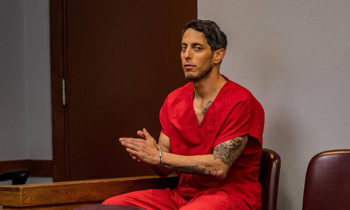 A handcuffed Oscar Olea gives a side-eyed glance during a break in the hearing on Thursday, March 7, 2024.