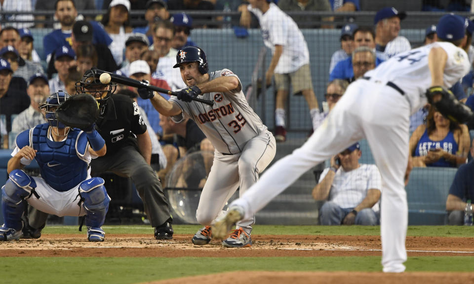 <p>Houston Astros starting pitcher Justin Verlander (35) hits a sacrifice bunt against the Los Angeles Dodgers in the third inning in game two of the 2017 World Series at Dodger Stadium. Mandatory Credit: Robert Hanashiro-USA TODAY Sports </p>