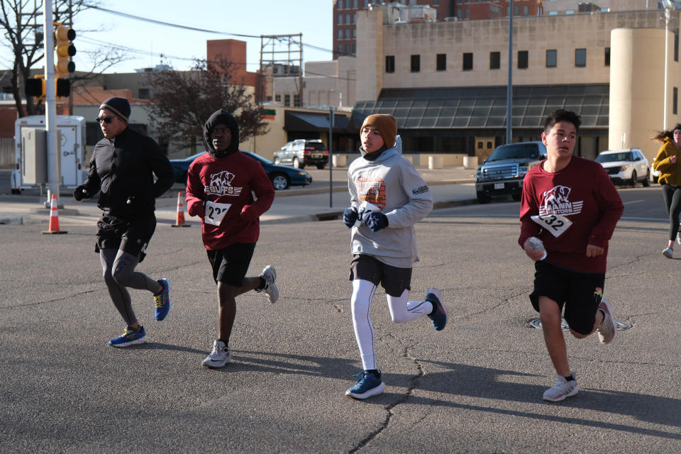 A group of runners run down Tyler Street Saturday in the 2023 Center City Mural Run in downtown Amarillo.