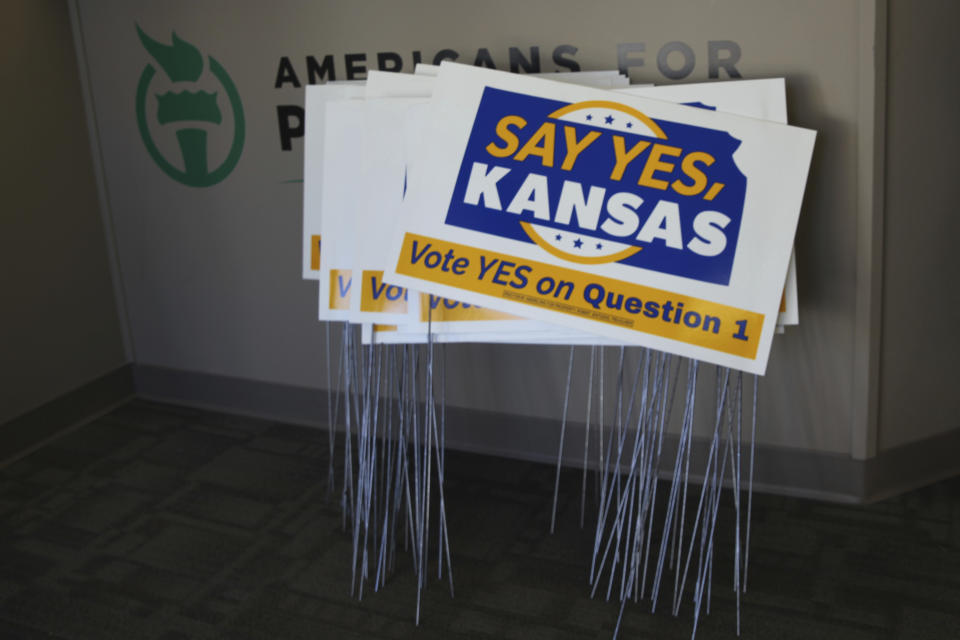 Signs, awaiting distribution, sit in the office of the Kansas chapter of the small-government group Americans for Prosperity promoting a proposed change in the Kansas Constitution, Tuesday, Oct. 25, 2022, in Topeka, Kan. The amendment would make it easier for the Legislature to overturn agency rules. (AP Photo/John Hanna)