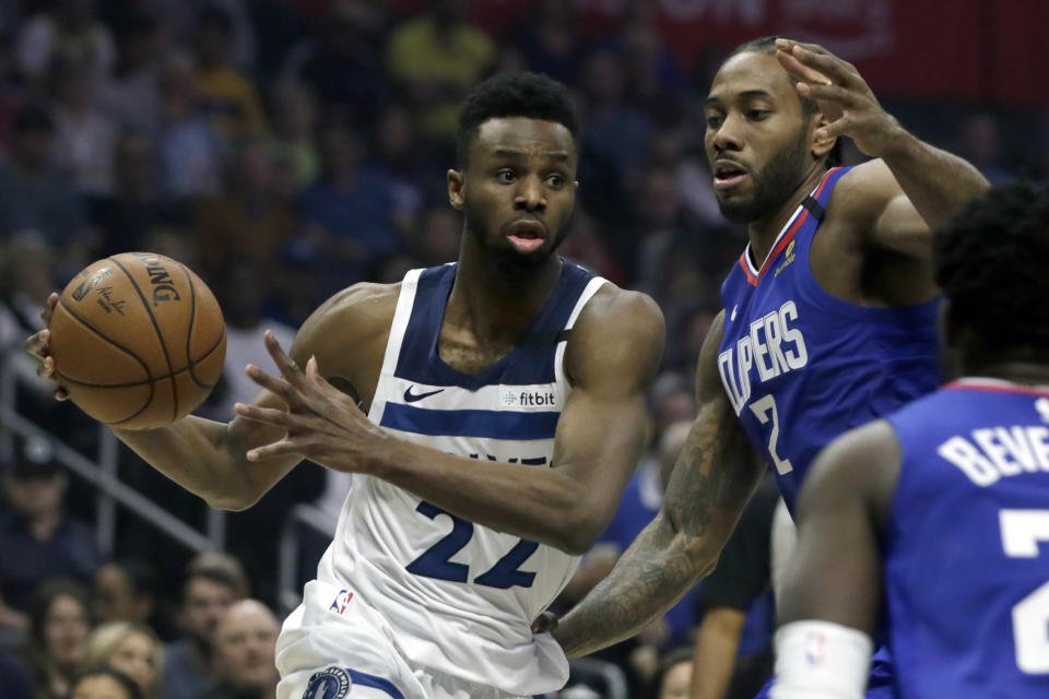 Minnesota Timberwolves guard Andrew Wiggins, left, drives to the basket again Los Angeles Clippers forward Kawhi Leonard (2) during the first half of an NBA basketball game in Los Angeles, Saturday, Feb. 1, 2020. (AP Photo/Alex Gallardo)