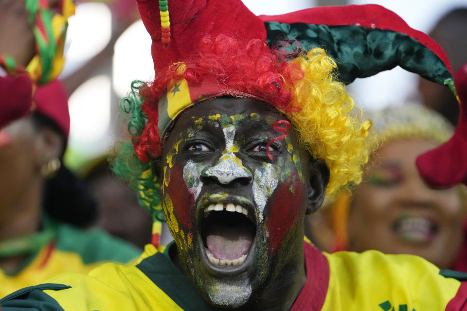 Senegal fan cheer his team during the African Cup of Nations Group C soccer match between Senegal and Cameroon, at the Charles Konan Banny stadium in Yamoussoukro, Ivory Coast, Friday, Jan. 19, 2024. (AP Photo/Sunday Alamba)