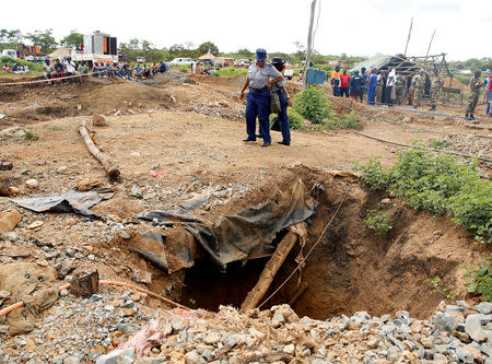 Police look on near a shaft as retrieval efforts proceed for trapped illegal gold miners in Kadoma, Zimbabwe, February 15, 2019, REUTERS/Philimon Bulawayo