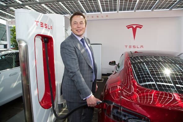 LONDON, ENGLAND - Saturday, June 7, 2014: CEO & Chief Product Architect Elon Musk plugs in a Supercharger to a right-hand drive Model S at the UK launch of Tesla Motors' Model S electric car at the Crystal. (Pic by David Rawcliffe/Propaganda)