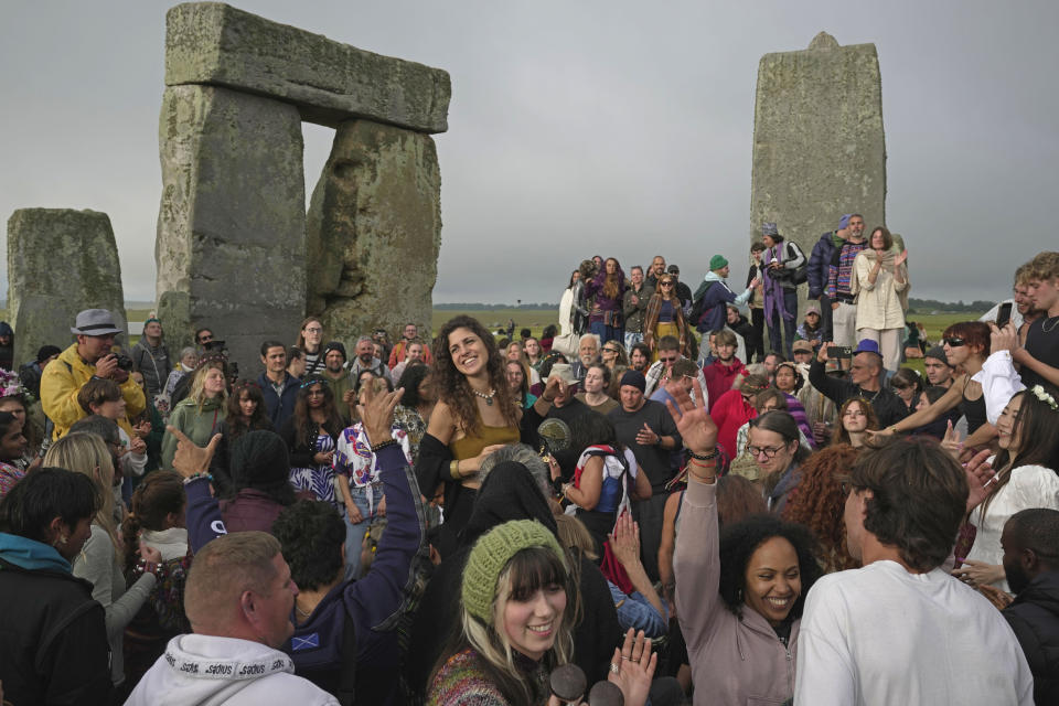 Revelers gather at the ancient stone circle Stonehenge to celebrate the Summer Solstice, the longest day of the year, near Salisbury, England, Wednesday, June 21, 2023. (AP Photo/Kin Cheung)