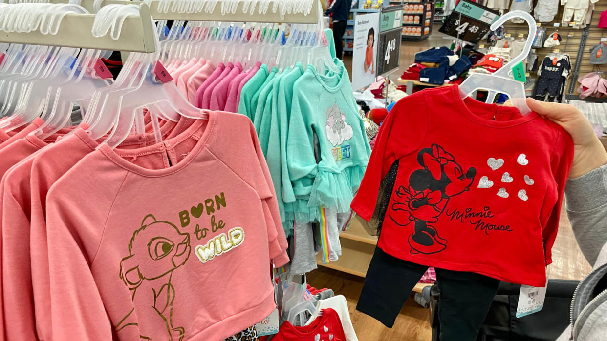 San Jose, CA - November 23, 2019: Young woman looking through clothes on a rack at Walmart store.