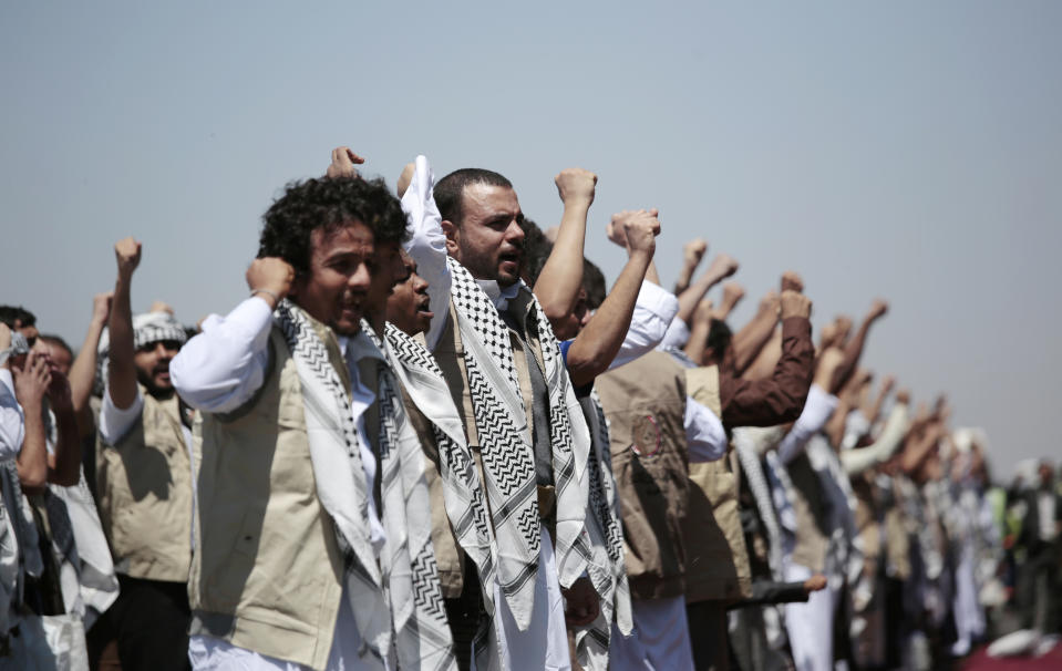 FILE - In this Oct. 16, 2020, file photo, Yemeni prisoners chant slogans during their arrival after being released by the Saudi-led coalition at the airport in Sanaa, Yemen. President Joe Biden is distancing himself from Saudi Arabia's rulers over their war in Yemen and rights abuses. That includes Biden announcing Feb. 4, 2021, he would make good on a campaign pledge to cut U.S. support for a five-year Saudi-led military campaign in neighboring Yemen (AP Photo/Hani Mohammed, File)