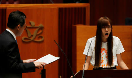 Newly elected lawmaker Yau Wai-ching takes oath at the Legislative Council. REUTERS/Bobby Yip