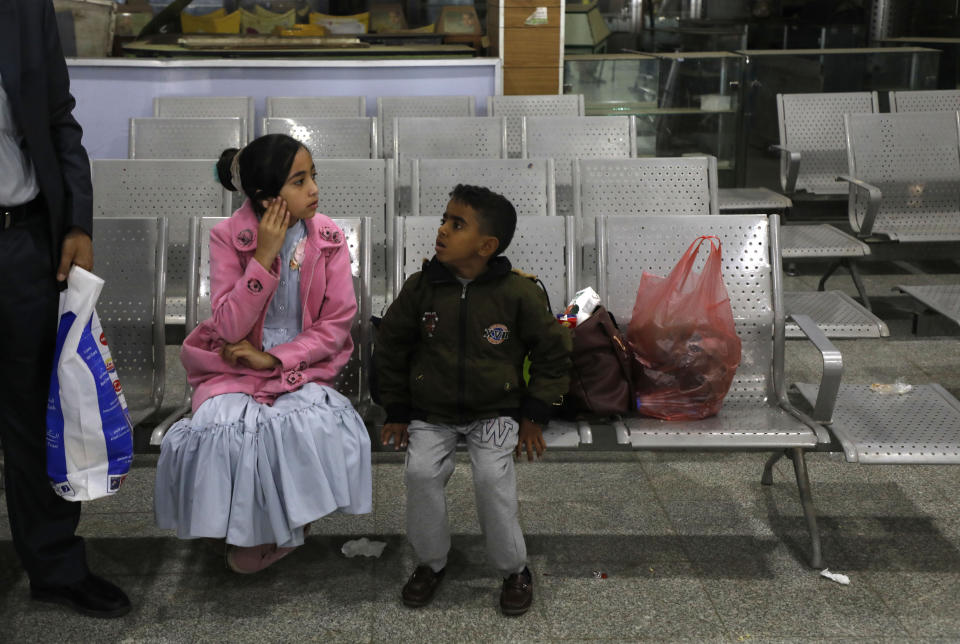 A Yemeni girl and boy wait in the departure lounge at Sanaa International airport, in Yemen, Monday, Feb. 3, 2020. A United Nations medical relief flight carrying patients from Yemen's rebel-held capital took off Monday, the first such aid flight in over three years. (AP Photo/Hani Mohammed)