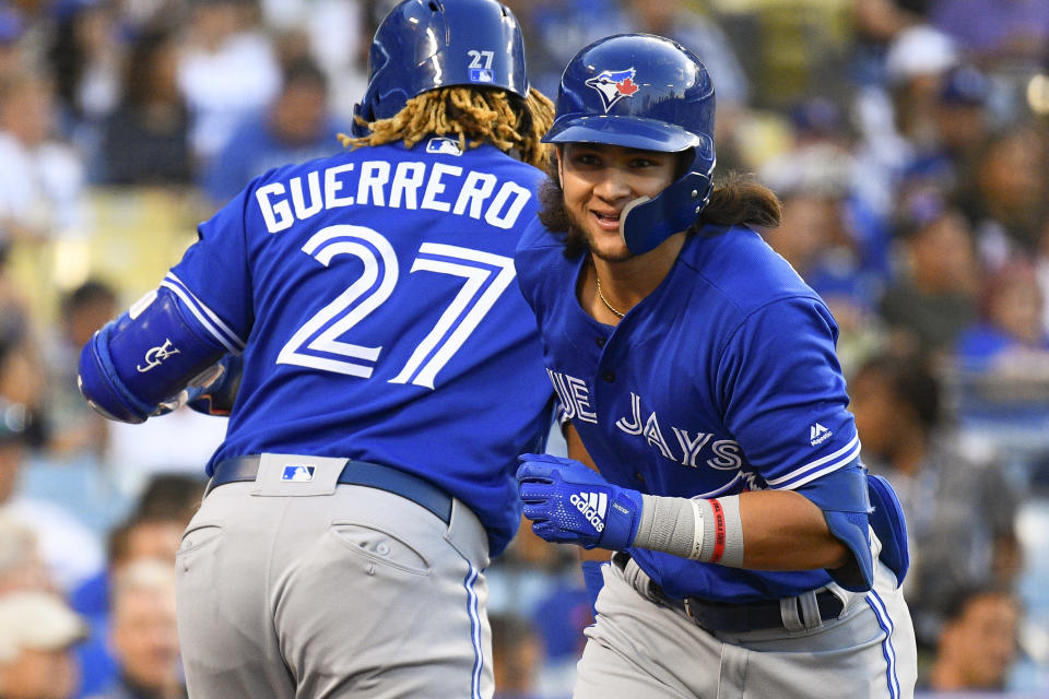 LOS ANGELES, CA - AUGUST 20: Toronto Blue Jays shortstop Bo Bichette (11) celebrates a home run with Toronto Blue Jays third baseman Vladimir Guerrero Jr. (27) during a MLB game between the Toronto Blue Jays and the Los Angeles Dodgers on August 20, 2019 at Dodger Stadium in Los Angeles, CA. (Photo by Brian Rothmuller/Icon Sportswire via Getty Images)