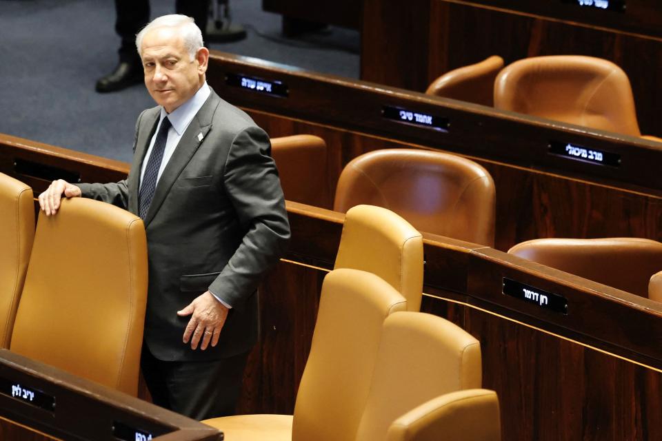 Israeli Prime Minister Benjamin Netanyahu stands at the Knesset, Israel's parliament in Jerusalem, on March 27, 2023.