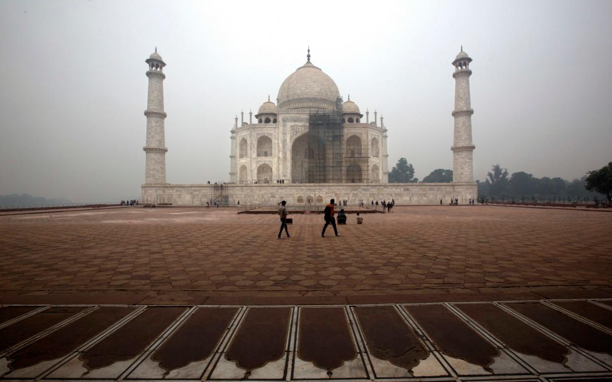 Workers are using clay to remove blemishes from the Taj Mahal's marble but haven't yet figured out how to tackle its dome - AP