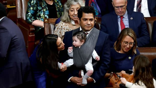 PHOTO: FILE - U.S. Rep. Alexandria Ocasio-Cortez talks to the infant child of Rep. Jimmy Gomez inside the House Chamber during votes for the next Speaker of the House on the first day of the 118th Congress at the U.S. Capitol in Washington, Jan. 3, 2023. (Evelyn Hockstein/Reuters, FILE)