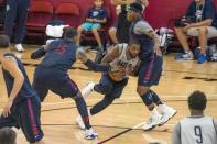 Jul 19, 2016; Las Vegas, NV, USA; USA guard Kyrie Irving (10) goes between USA forward Carmelo Anthony (15) and guard Kyle Lowry (7) during a practice at Mendenhall Center. Mandatory Credit: Joshua Dahl-USA TODAY Sports