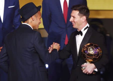 FC Barcelona's Lionel Messi of Argentina (R) shakes hand with FC Barcelona's Neymar'of Brazil after receiving the World Player of the Year award during the FIFA Ballon d'Or 2015 ceremony in Zurich, Switzerland, January 11, 2016. REUTERS/Arnd Wiegmann