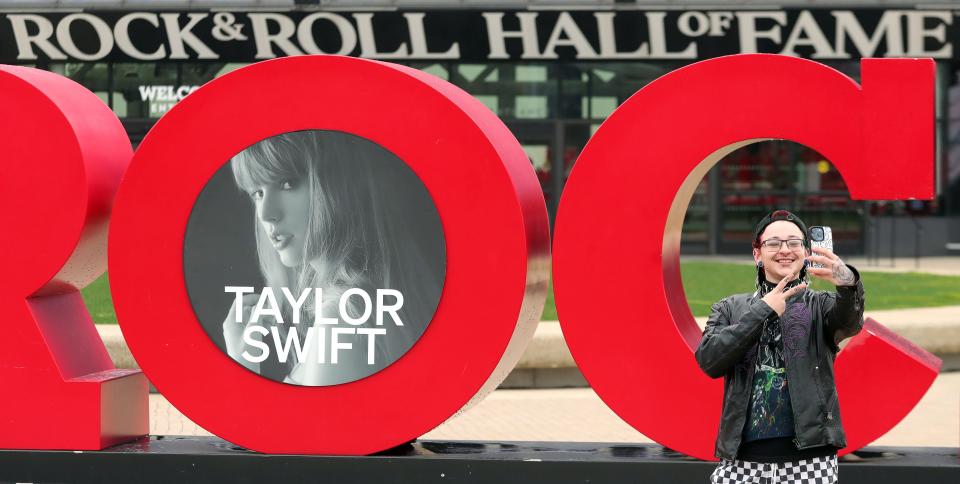 Aiden Abruzzino takes a selfie in front of the Rock and Roll Hall of Fame in Cleveland on Taylor Swift Fan Dan Friday. Aiden said he and his friends decided last-minute to drive in from New York late Thursday night to celebrate the release of Taylor's latest album,"The Tortured Poets Department," with other Swifties at the Rock Hall.