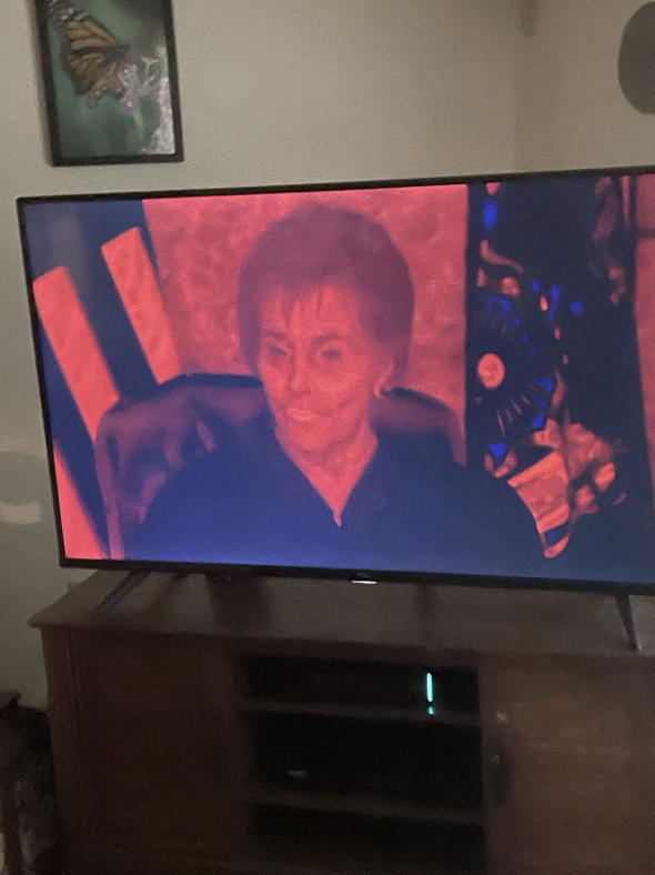 judge judy on the screen with red lighting