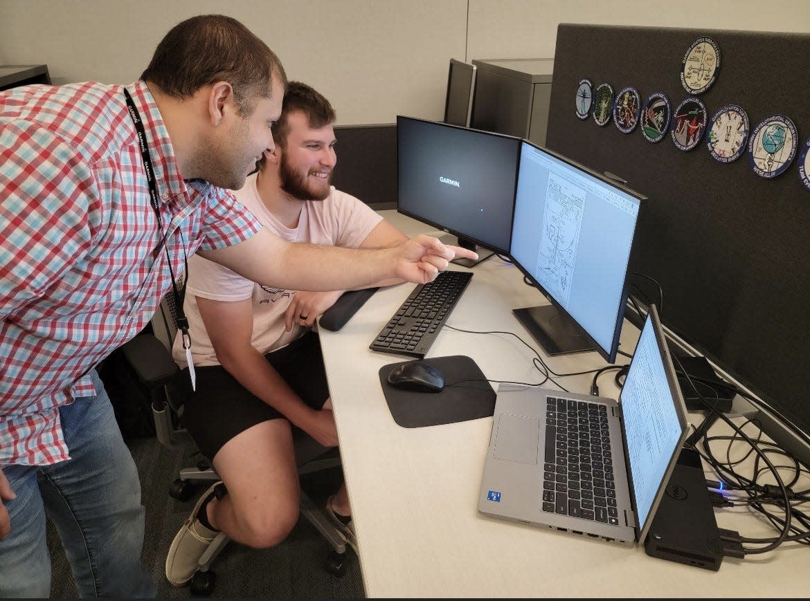 Guillermo De Jesus Vega (left) is shown training with former Garmin intern David McCune (right). McCune was hired as a full-time associate following his internship.
