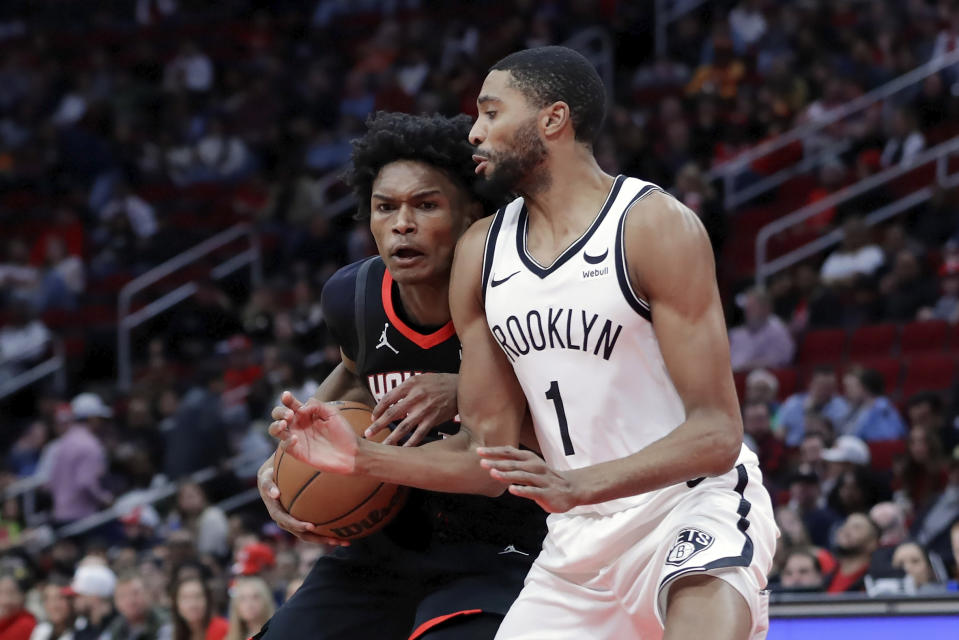 Houston Rockets forward Amen Thompson, left, drives into Brooklyn Nets forward Mikal Bridges (1) during the first half of an NBA basketball game Wednesday, Jan. 3, 2024, in Houston. (AP Photo/Michael Wyke)