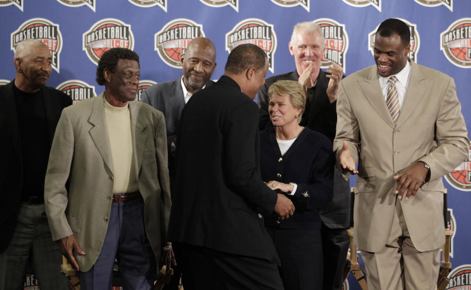 FILE - Basketball Hall of Fame finalist Jamaal Wilkes, center, is greeted by George Gervin, from left, Elgin Baylor, James Worthy, Ann Meyers Drysdale, Bill Walton and David Robinson during a news conference announcing the 2011 Hall of Fame finalists at the NBA All Star weekend in Los Angeles, Friday, Feb. 18, 2011. Marsha Sharp, Ann Meyers Drysdale, Debbie Ryan and others all worked their way through the nascent days of Title IX to the heights of women’s basketball. (AP Photo/Jae C. Hong, File)