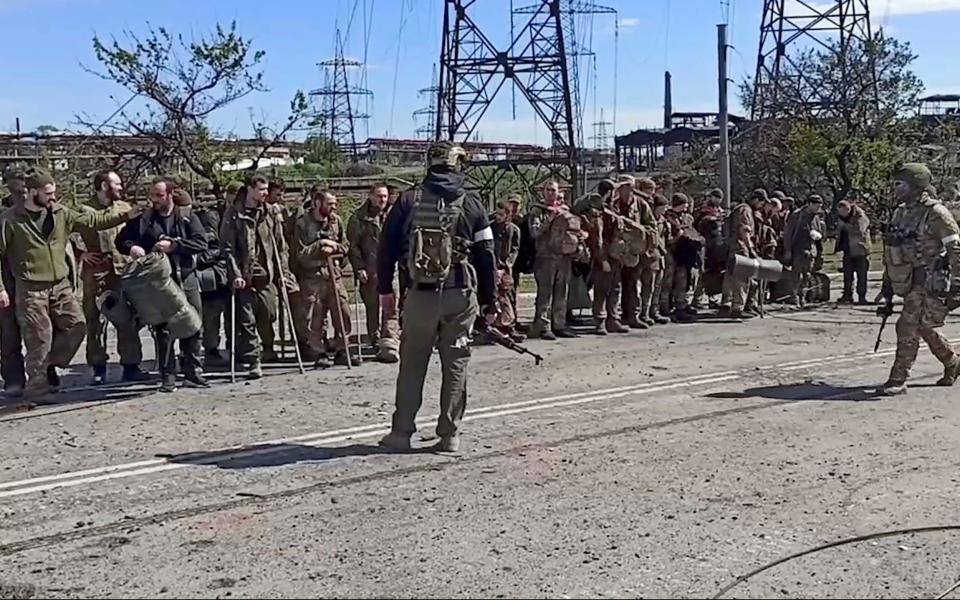 Ukrainian servicemen from the besieged Azovstal steel plant surrender to Russian forces on May 17 - Shutterstock