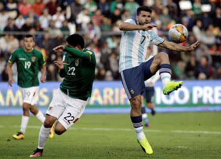 Football Soccer - Bolivia v Argentina - World Cup 2018 Qualifiers - Hernando Siles stadium, La Paz, Bolivia - 28/3/17. Argentina's Sergio Aguero and Bolivia's Edward Zenteno in action. REUTERS/Daniel Rodrigo