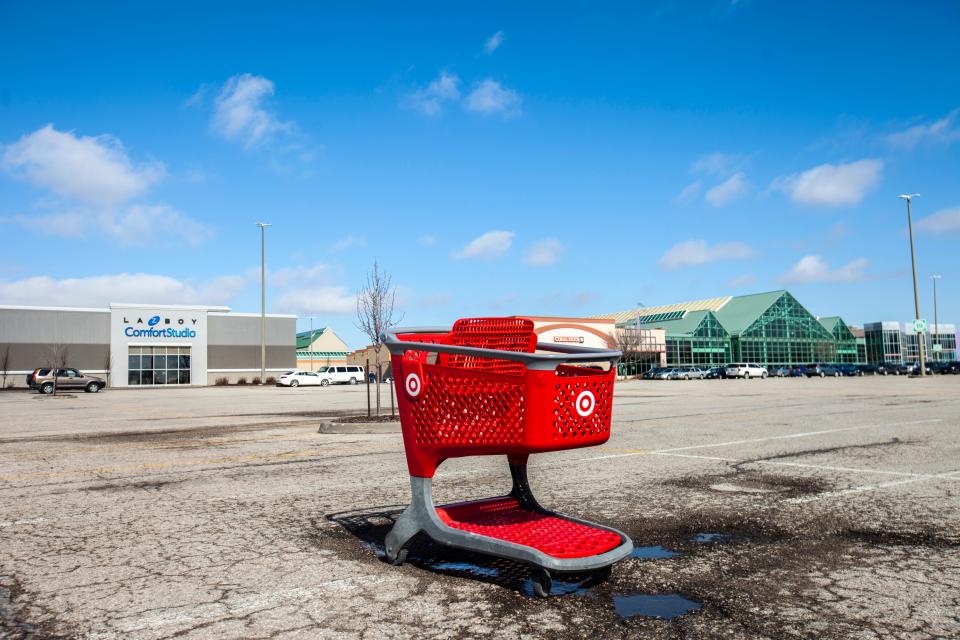 An abandoned Target shopping cart sits in a parking lot.