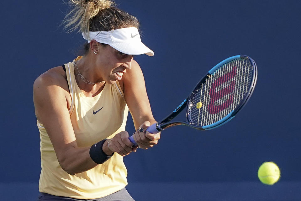 Madison Keys, of the United States, returns to Simona Halep, of Romania, during the quarterfinals of the Western & Southern Open tennis tournament, Thursday, Aug. 15, 2019, in Mason, Ohio. (AP Photo/John Minchillo)