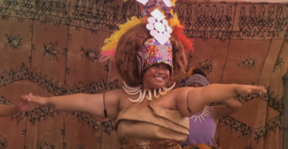 a woman wearing a tuiga while dancing