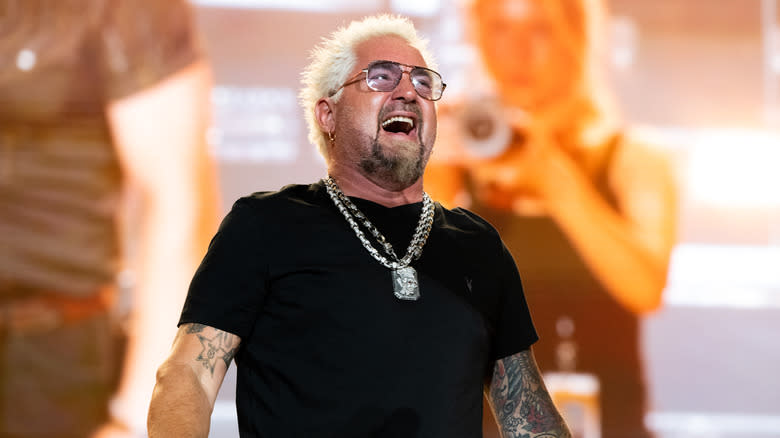 Guy Fieri laughing on stage