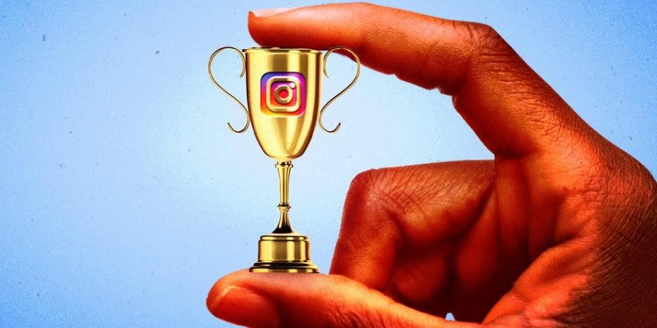 A photo illustration of a hand holding a tiny trophy between its thumb and pointer finger. The trophy has the Instagram logo on it.