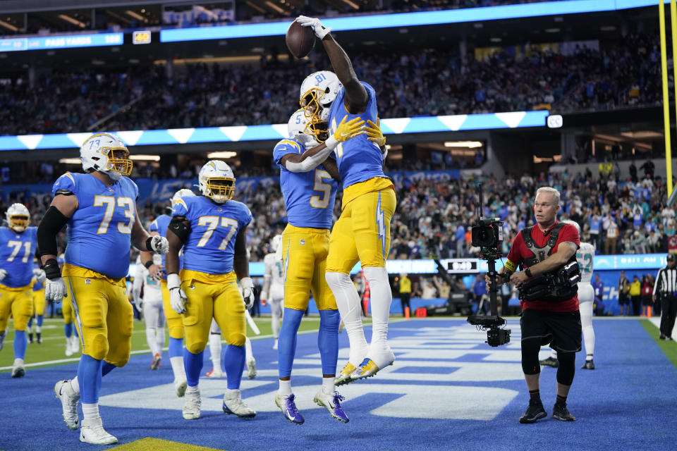 Los Angeles Chargers wide receiver Mike Williams, right, celebrates his touchdown catch with wide receiver Joshua Palmer (5) during the first half of an NFL football game against the Miami Dolphins Sunday, Dec. 11, 2022, in Inglewood, Calif. (AP Photo/Jae C. Hong)