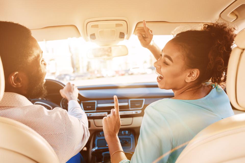 Couple listening to music on a road trip