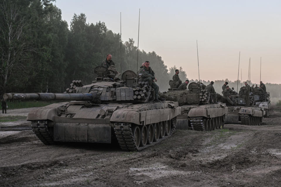 Polish soldiers stand on tanks after a training demonstration with the NATO multinational battle group eFPon at the Orzysz training ground on July 3, 2022 in Orzysz, Poland.<span class="copyright">Omar Marques—Getty Images</span>