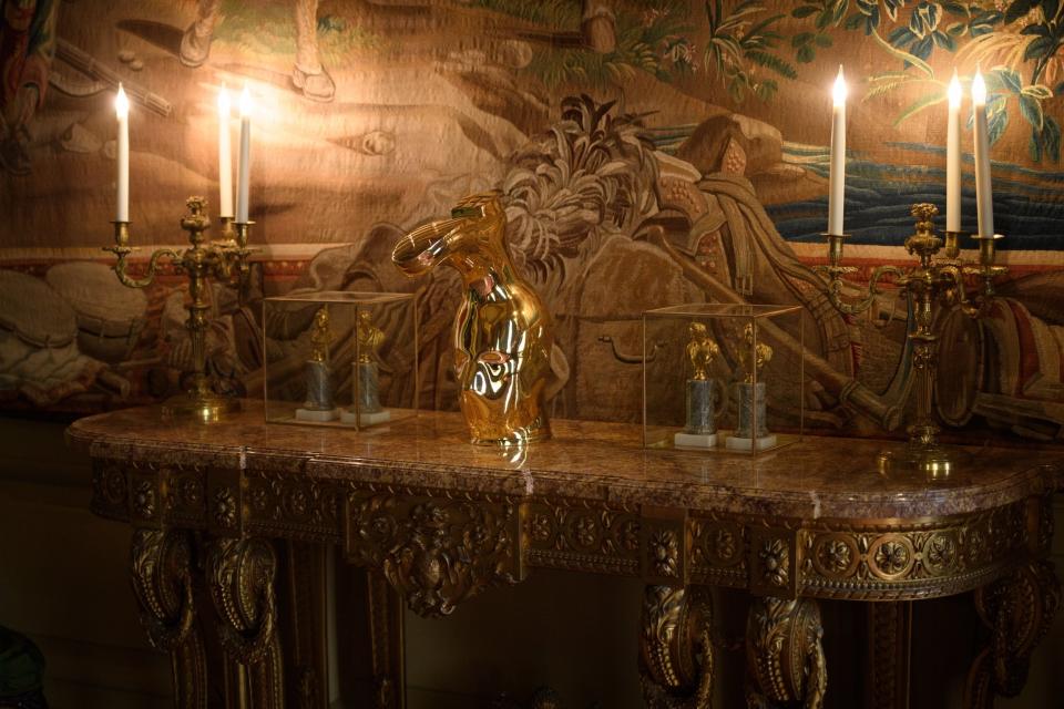 A gold version of Maurizio Cattelan's head inside a wellington boot is among the new exhibition's dazzling pieces (Getty Images)