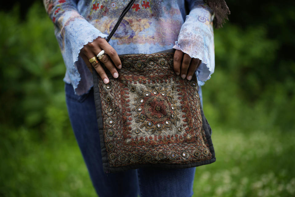 Yasmeen Bekhit, a 22-year-old graduate student, holds her Y2K-inspired bag while posing for a photograph near her home in Manheim, Pa., Tuesday, June 27, 2023. If there’s one thing retailers will tell you, it’s that Gen Z hasn’t let up on early 2000s trends that are booming in popularity two decades later. (AP Photo/Matt Slocum)