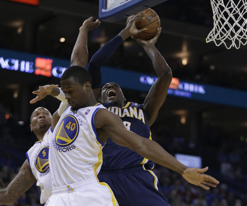Indiana Pacers' Ian Mahinmi shoots over Golden State Warriors' Harrison Barnes (40) and Marreese Speights (5) during the second half of an NBA basketball game Monday, Jan. 20, 2014, in Oakland, Calif. (AP Photo/Ben Margot)
