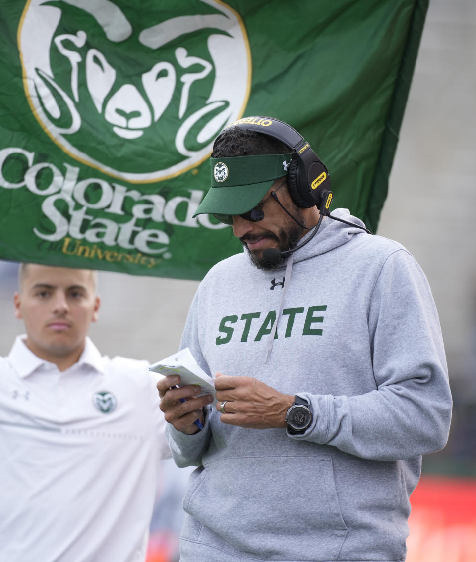 Colorado State head coach Jay Norvell studies notes in the first half of an NCAA college football game against Nevada on Saturday, Nov. 18, 2023, in Fort Collins, Colo. (AP Photo/David Zalubowski)