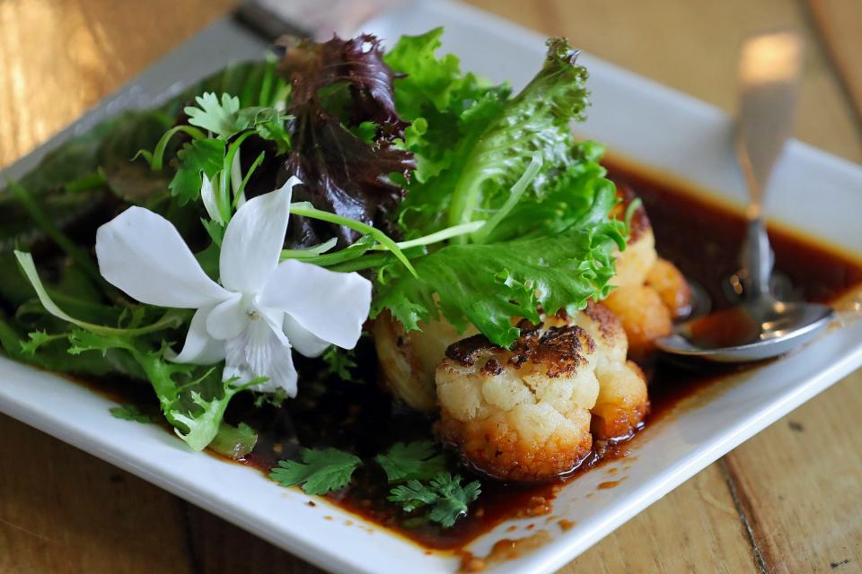 Barrelhouse's cauliflower steak served with herb salad.