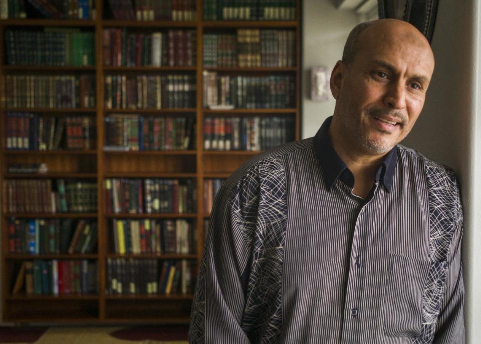 Hakim Ouansafi, president of the Muslim Association of Hawaii, speaks about an amended lawsuit filed by the Hawaii attorney general, during an interview in the library room of the association's mosque, Thursday, March 9, 2107, in Honolulu. Hawaii has only 5,000 or so Muslims, less than 1 percent of the state's population, but the immigrants from countries that include all six named in President Donald Trump's revised travel ban have found themselves thrust into the spotlight after the state's top prosecutor launched a challenge to the ban and said it runs counter to the islands' inclusive and welcoming "Aloha" culture that values diversity. (AP Photo/Marco Garcia)